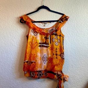 A beautiful light burnt orange sleeveless top, with tie at waist. Size medium.